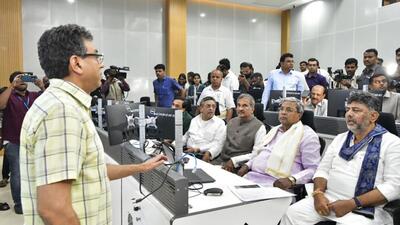 Chief minister Siddaramaiah, along with deputy CM DK Shivakumar, receives updates from BBMP administrative officer Tushar Girinath at the BBMP War Room, on Monday. (PTI) Chief minister Siddaramaiah, along with deputy CM DK Shivakumar, receives updates from BBMP administrative officer Tushar Girinath at the BBMP War Room, on Monday. (PTI)