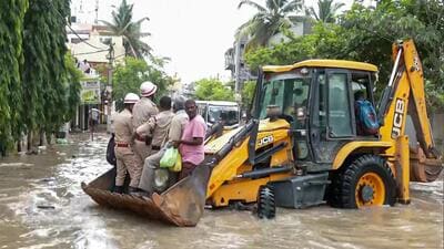 Police personnel using a JCB to evacuate stranded people after several areas got inundated with water following torrential rains in Bengaluru on Monday. (A (ANI) Police personnel using a JCB to evacuate stranded people after several areas got inundated with water following torrential rains in Bengaluru on Monday. (A (ANI)