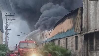 Smoke billowing from the tyre factory as fire tenders try to control the blaze in Jalandhar’s industrial focal point area on Monday. (HT Photo)