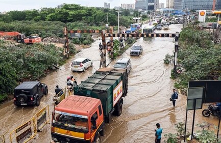 Commuters wade through a severely waterlogged road, after incessant rainfall in several parts Bengaluru, at Sai Layout on Monday. (ANI) Commuters wade through a severely waterlogged road, after incessant rainfall in several parts Bengaluru, at Sai Layout on Monday. (ANI)
