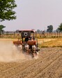 A farmer works on a field close to the India-Pakistan border fencing in Amritsar. (PTI File) A farmer works on a field close to the India-Pakistan border fencing in Amritsar. (PTI File)