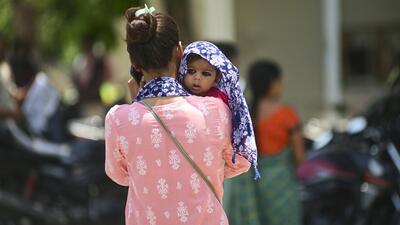 A woman shields her child from the scorching heat on a hot summer day in Prayagraj. (PTI Photo) A woman shields her child from the scorching heat on a hot summer day in Prayagraj. (PTI Photo)