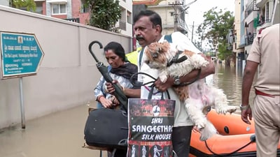 Police personnel rescued a family and their pet dog after several areas get severely waterlogged following heavy rainfall, in Bengaluru on Monday. (ANI) Police personnel rescued a family and their pet dog after several areas get severely waterlogged following heavy rainfall, in Bengaluru on Monday. (ANI)