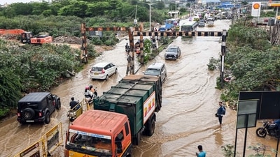 Commuters wade through a severly waterlogged road after incessant rainfall in several parts of the region, at Sai Layout in Bengaluru on Monday. (Savitha) Commuters wade through a severly waterlogged road after incessant rainfall in several parts of the region, at Sai Layout in Bengaluru on Monday. (Savitha)