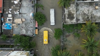 An aerial view shows a school bus passing through a flooded locality following heavy rainfall. (Photo by Idrees MOHAMMED / AFP) (AFP) An aerial view shows a school bus passing through a flooded locality following heavy rainfall. (Photo by Idrees MOHAMMED / AFP) (AFP)