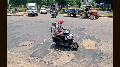 Potholes seen on the road dividing Sector 47 and 31 in Chandigarh on Tuesday. (Ravi Kumar/Hindustan Times) Potholes seen on the road dividing Sector 47 and 31 in Chandigarh on Tuesday. (Ravi Kumar/Hindustan Times)