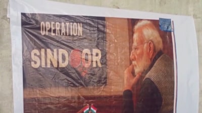 Poster used by artisans as reference for crafting stone portrait of Prime Minister Narendra Modi. (Video grab) Poster used by artisans as reference for crafting stone portrait of Prime Minister Narendra Modi. (Video grab)