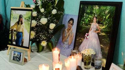 Candles, flowers and photos of America Sanchez, a cadet who died after the Mexican Navy ship Cuauhtemoc crashed into the Brooklyn Bridge in New York City, are kept on a table as family and friends gather to pay tribute to her at her home in Xalapa, Mexico May 18, 2025. REUTERS/Oscar Martinez (REUTERS)