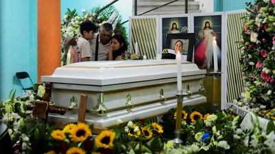 Relatives of America Sanchez, a cadet who died when the Mexican Navy ship Cuauhtemoc crashed into the Brooklyn Bridge in New York City, embrace beside her casket during a wake at her home in Xalapa, Mexico, May 20, 2025. REUTERS/Oscar Martinez (REUTERS)