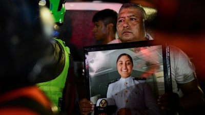 Cosme Sanchez holds a framed photo of his daughter, America Sanchez, a cadet who died when the Mexican Navy ship Cuauhtemoc crashed into the Brooklyn Bridge in New York City, as her casket arrives for the wake in Xalapa, Mexico, May 19, 2025. REUTERS/Oscar Martinez (REUTERS)