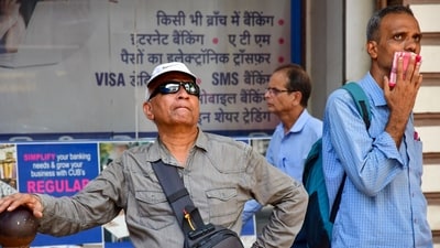 People watch the stock market updates on a screen outside the Bombay Stock Exchange (BSE) building in Mumbai. (File photo) People watch the stock market updates on a screen outside the Bombay Stock Exchange (BSE) building in Mumbai. (File photo)