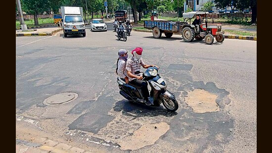 Potholes seen on the road dividing Sector 47 and 31 in Chandigarh on Tuesday. (Ravi Kumar/Hindustan Times)
