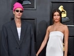 Hailey Bieber's Vogue cover marks her modeling success, but her husband Justin's Instagram post sparked controversy. Reports suggest their relationship is marked with 'love hard, fight hard' phenomenon.
 (Photo by ANGELA  WEISS / AFP)
