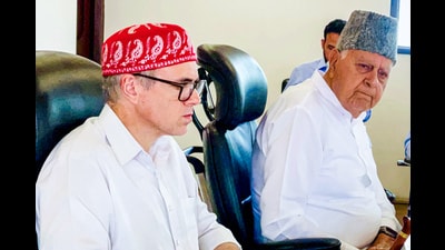 NC chief Farooq Abdullag and party vice-president and J&K chief minister Omar Abdullah during the party's central working committee meeting, at party headquarters in Srinagar on Wednesday. (ANI)
