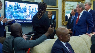 South African businessman Johann Rupert, standing right, watches a video during a meeting between President Donald Trump and South African President Cyril Ramaphosa in the Oval Office of the White House, Wednesday, May 21, 2025, in Washington. (AP Photo/Evan Vucci) (AP) South African businessman Johann Rupert, standing right, watches a video during a meeting between President Donald Trump and South African President Cyril Ramaphosa in the Oval Office of the White House, Wednesday, May 21, 2025, in Washington. (AP Photo/Evan Vucci) (AP)