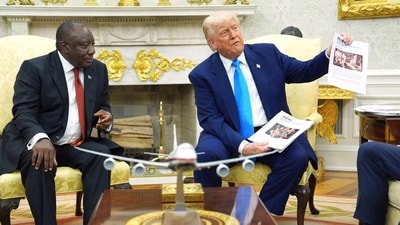 President Donald Trump shows documents to South Africa's President Cyril Ramaphosa in the Oval Office of the White House, Wednesday, May 21, 2025, in Washington. (AP Photo/Evan Vucci) (AP) President Donald Trump shows documents to South Africa's President Cyril Ramaphosa in the Oval Office of the White House, Wednesday, May 21, 2025, in Washington. (AP Photo/Evan Vucci) (AP)