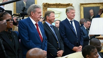 South African businessman Johann Rupert (L) speaks during a meeting with US President Donald Trump and South African President Cyril Ramaphosa in the Oval Office of the White House in Washington, DC, on May 21, 2025. South African President Cyril Ramaphosa meets Donald Trump on Wednesday amid tensions over Washington's resettlement of white Afrikaners that the US president claims are the victims of "genocide." (Photo by Jim WATSON / AFP) (AFP) South African businessman Johann Rupert (L) speaks during a meeting with US President Donald Trump and South African President Cyril Ramaphosa in the Oval Office of the White House in Washington, DC, on May 21, 2025. South African President Cyril Ramaphosa meets Donald Trump on Wednesday amid tensions over Washington's resettlement of white Afrikaners that the US president claims are the victims of "genocide." (Photo by Jim WATSON / AFP) (AFP)