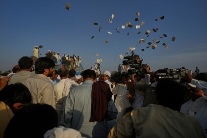 Members of a team blow currency notes in the air as they celebrating after winning a traditional bull race competition, in Malal, a village of Attock district, in Pakistan, Thursday, May 15, 2025. (Anjum Naveed/AP) Members of a team blow currency notes in the air as they celebrating after winning a traditional bull race competition, in Malal, a village of Attock district, in Pakistan, Thursday, May 15, 2025. (Anjum Naveed/AP)