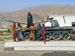 Taliban security personnel pose on a Soviet tank along a road in Surobi district, Kabul province on May 20, 2025. Taliban security personnel pose on a Soviet tank along a road in Surobi district, Kabul province on May 20, 2025.
