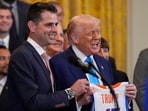 President Donald Trump and head coach Todd Golden poses with a jersey as Trump hosts the 2025 NCAA Champion, University of Florida men's basketball team in the East Room of the White House, Wednesday, May 21, 2025, in Washington. AP/PTI(AP05_22_2025_000009B)