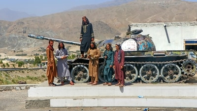 Taliban security personnel pose on a Soviet tank along a road in Surobi district, Kabul province on May 20, 2025. (AFP) Taliban security personnel pose on a Soviet tank along a road in Surobi district, Kabul province on May 20, 2025. (AFP)