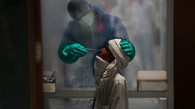 A health worker takes a nasal swab of a person for a Covid-19 test at a hospital in New Delhi. (AP file) A health worker takes a nasal swab of a person for a Covid-19 test at a hospital in New Delhi. (AP file)