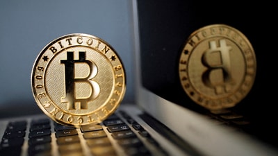 A bitcoin is seen in an illustration picture taken at La Maison du Bitcoin in Paris, France. (REUTERS)