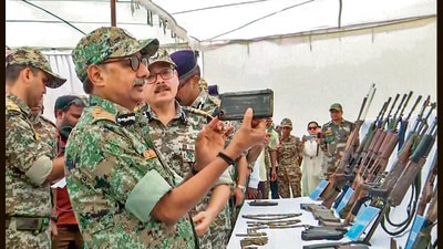 IG Bastar P Sundarraj inspects the weapons recovered during the encounter on Thursday. (ANI)