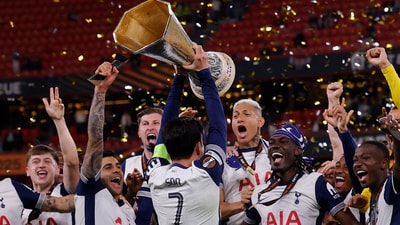 Tottenham Hotspur's Son Heung-min lifts the trophy with teammates after winning the Europa League Final. (REUTERS)