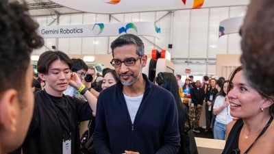 Google CEO Sundar Pichai (C) walks through the AI Sandbox, where attendees can partake in AI driven activities, during Google's annual I/O developers conference in Mountain View, California. (AFP) Google CEO Sundar Pichai (C) walks through the AI Sandbox, where attendees can partake in AI driven activities, during Google's annual I/O developers conference in Mountain View, California. (AFP)