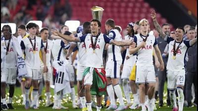 Tottenham players celebrate with the trophy after winning the Europa League. (AP)