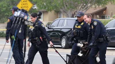 San Diego Police help evacuate a dog from a residence after a Cessna plane crashed in the Murphy Canyon area of San Diego, California, on May 22, 2025. The Federal Aviation Authority said a Cessna 550 crashed at around 3:45 am local time. The neighborhood is close to the Montgomery-Gibbs Executive Airport. The crash left a "gigantic debris field" and damaged some 15 homes and parked cars, ABC News quoted the San Diego assistant fire chief as saying. (Photo by Sandy Huffaker / AFP) (AFP) San Diego Police help evacuate a dog from a residence after a Cessna plane crashed in the Murphy Canyon area of San Diego, California, on May 22, 2025. The Federal Aviation Authority said a Cessna 550 crashed at around 3:45 am local time. The neighborhood is close to the Montgomery-Gibbs Executive Airport. The crash left a "gigantic debris field" and damaged some 15 homes and parked cars, ABC News quoted the San Diego assistant fire chief as saying. (Photo by Sandy Huffaker / AFP) (AFP)
