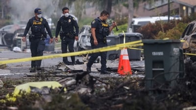 Investigators look through the site where a small plane crashed into San Diego, California, residential street on May 22, 2025. The Federal Aviation Authority said a Cessna 550 crashed at around 3:45 am local time. The neighborhood is close to the Montgomery-Gibbs Executive Airport. The crash left a "gigantic debris field" and damaged some 15 homes and parked cars, ABC News quoted the San Diego assistant fire chief as saying. (Photo by Sandy Huffaker / AFP) (AFP) Investigators look through the site where a small plane crashed into San Diego, California, residential street on May 22, 2025. The Federal Aviation Authority said a Cessna 550 crashed at around 3:45 am local time. The neighborhood is close to the Montgomery-Gibbs Executive Airport. The crash left a "gigantic debris field" and damaged some 15 homes and parked cars, ABC News quoted the San Diego assistant fire chief as saying. (Photo by Sandy Huffaker / AFP) (AFP)