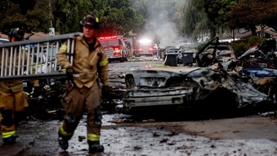 Firefighters work the site where a small plane crashed into a San Diego, California, residential street on May 22, 2025. The Federal Aviation Authority said a Cessna 550 crashed at around 3:45 am local time. The neighborhood is close to the Montgomery-Gibbs Executive Airport. The crash left a "gigantic debris field" and damaged some 15 homes and parked cars, ABC News quoted the San Diego assistant fire chief as saying. (Photo by Sandy Huffaker / AFP) (AFP) Firefighters work the site where a small plane crashed into a San Diego, California, residential street on May 22, 2025. The Federal Aviation Authority said a Cessna 550 crashed at around 3:45 am local time. The neighborhood is close to the Montgomery-Gibbs Executive Airport. The crash left a "gigantic debris field" and damaged some 15 homes and parked cars, ABC News quoted the San Diego assistant fire chief as saying. (Photo by Sandy Huffaker / AFP) (AFP)