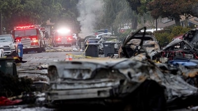 Firefighters work the site where a small plane crashed into a San Diego, California, residential street on May 22, 2025. The Federal Aviation Authority said a Cessna 550 crashed at around 3:45 am local time. The neighborhood is close to the Montgomery-Gibbs Executive Airport. The crash left a "gigantic debris field" and damaged some 15 homes and parked cars, ABC News quoted the San Diego assistant fire chief as saying. (Photo by Sandy Huffaker / AFP) (AFP) Firefighters work the site where a small plane crashed into a San Diego, California, residential street on May 22, 2025. The Federal Aviation Authority said a Cessna 550 crashed at around 3:45 am local time. The neighborhood is close to the Montgomery-Gibbs Executive Airport. The crash left a "gigantic debris field" and damaged some 15 homes and parked cars, ABC News quoted the San Diego assistant fire chief as saying. (Photo by Sandy Huffaker / AFP) (AFP)