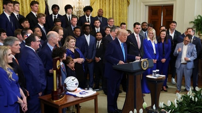 Donald Trump tells Florida basketball star Thomas Haugh he has “no hair loss problems” during his congratulatory speech for the college basketball national champion. (REUTERS)