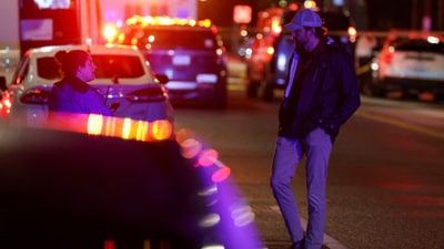 A man speaks to an emergency personnel working at the site where, according to the U.S. Homeland Security Secretary, two Israeli embassy staff were shot dead near the Capital Jewish Museum in Washington, D.C., U.S. May 21, 2025.  REUTERS/Jonathan Ernst (REUTERS)