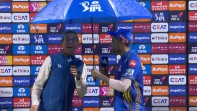 Suryakumar Yadav shares umbrella with Harsha Bhogle during the post-match presentation (IPL) Suryakumar Yadav shares umbrella with Harsha Bhogle during the post-match presentation (IPL)