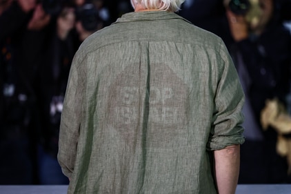 WikiLeaks founder Julian Assange wears a shirt with a slogan that reads "Stop Israel" as he poses during a photocall for the documentary film "The Six Billion Dollar Man" presented as part of Special Screenings at the 78th Cannes Film Festival in Cannes, France, May 20, 2025. REUTERS/Stephane Mahe (REUTERS)