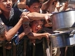 Palestinians struggle to receive cooked food distributed at a community kitchen in the Muwasi area of Khan Younis, in the Gaza Strip, Friday, May 23, 2025. Palestinians struggle to receive cooked food distributed at a community kitchen in the Muwasi area of Khan Younis, in the Gaza Strip, Friday, May 23, 2025.