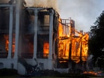 The north wing of the Nottoway Plantation starts to collapse as crews battle the fire on Thursday, May 15, 2025 in White Castle, La.  (Michael Johnson /The Advocate via AP)