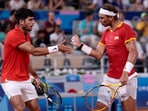 Carlos Alcaraz and Rafael Nadal react during a match at the 2024 Paris Olympics.