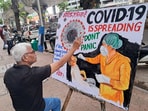 A school teacher makes an awareness painting of Covid in Mumbai on Wednesday