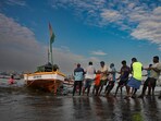 Fishermen removed their fishing boats from the Arabian Sea at Worli-Koliwada jetty after the state issued an alert for heavy rain and storms. Mumbai, India. Fishermen removed their fishing boats from the Arabian Sea at Worli-Koliwada jetty after the state issued an alert for heavy rain and storms. Mumbai, India.