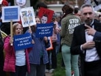 Protesters stood outside Trump National Golf Club with signs reading 'Stop crypto corruption', 'America is not for sale', as guests arrived to attend dinner hosted for $TRUMP memecoin holders.