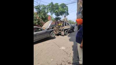 A dumped vehicle being towed away during an anti-encroachment drive by Chandigarh Municipal Corporation held in Sector 45 and Burail village on Friday. (HT Photo)