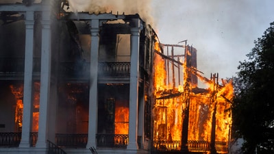 The north wing of the Nottoway Plantation starts to collapse as crews battle the fire on Thursday, May 15, 2025 in White Castle, La. (Michael Johnson /The Advocate via AP) (AP) The north wing of the Nottoway Plantation starts to collapse as crews battle the fire on Thursday, May 15, 2025 in White Castle, La. (Michael Johnson /The Advocate via AP) (AP)
