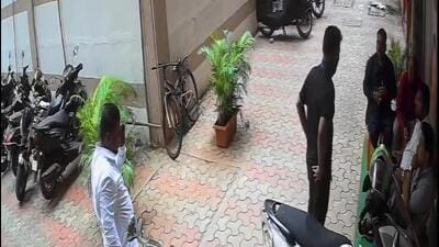 The accused (standing, dressed in black) was captured on a CCTV camera installed in the complainant’s office The accused (standing, dressed in black) was captured on a CCTV camera installed in the complainant’s office