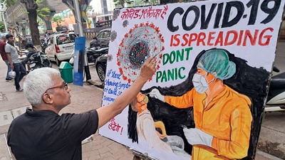 A school teacher makes an awareness painting of Covid in Mumbai on Wednesday (ANI)