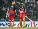 Royal Challengers Bengaluru's Virat Kohli (R) speaks with his teammate Phil Salt during the Indian Premier League (IPL) Twenty20 cricket match between Royal Challengers Bengaluru and Sunrisers Hyderabad